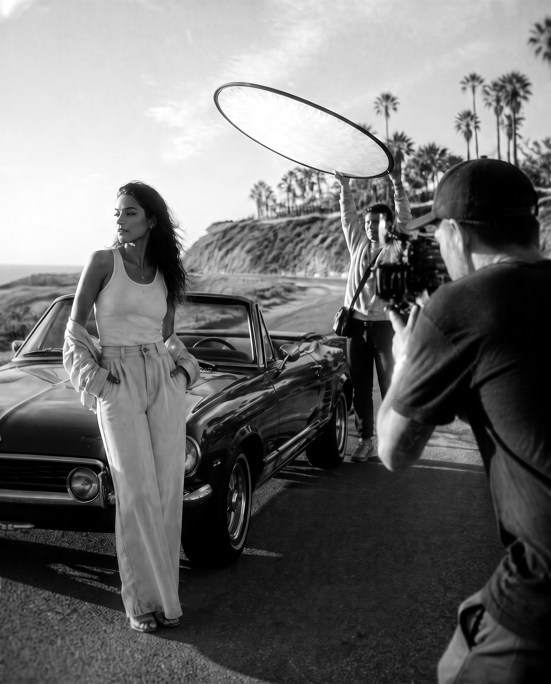 A singer filmed on a bright coastline during a music video shoot